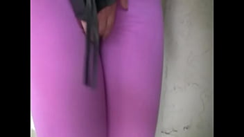 Blond girl pees her spandex leggings outside