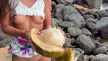 Naked girl found a coconut on a public beach and poured the juice over her body