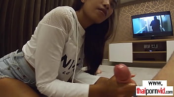 Amateur Thai teen Cherry giving a sensual handjob to a big white dick