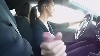 Girl driving a cock while driving in a car