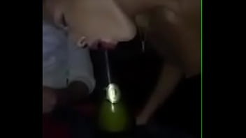 Girl sucks a bottle of champagne